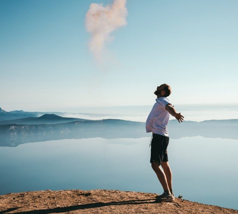 A happy man under a blue sky