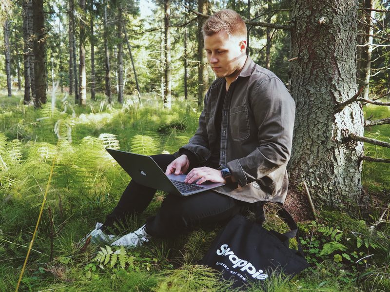 Man in woods on laptop