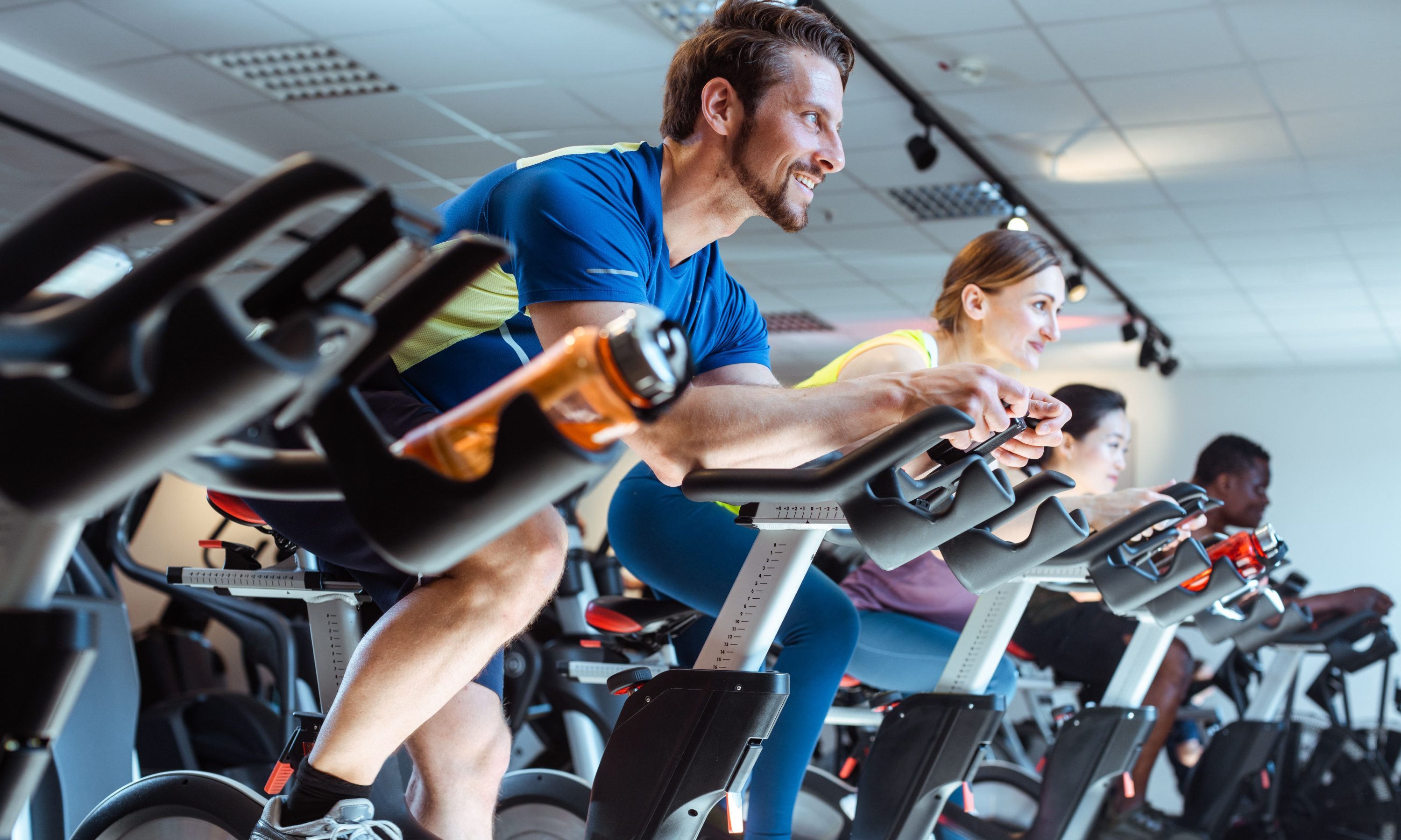Man on exercise bike with others
