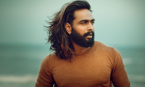 Man with long hair on beach with an undercut