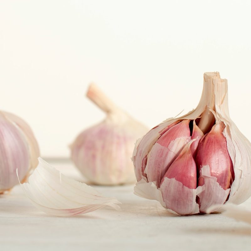 Half peeled garlic bulbs