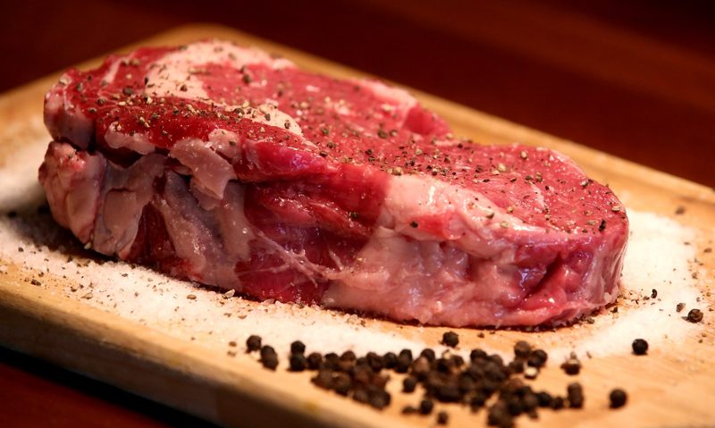Raw steak on cutting board