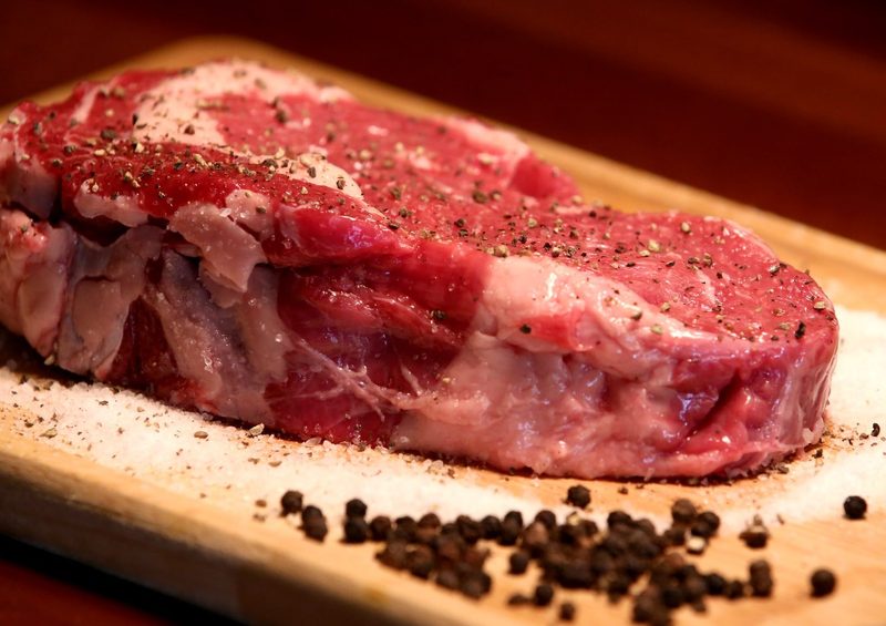 Raw steak on cutting board