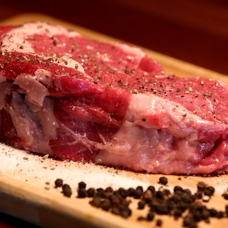 Raw steak on cutting board
