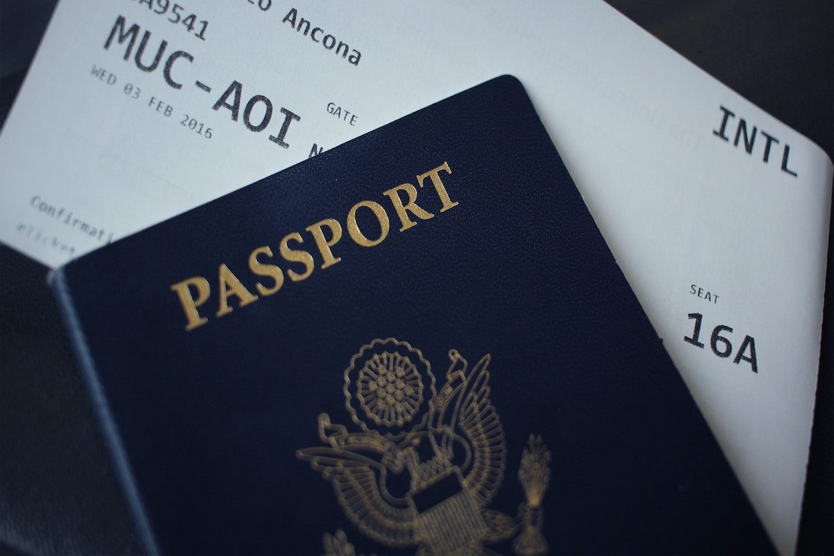 A passport with a boarding pass