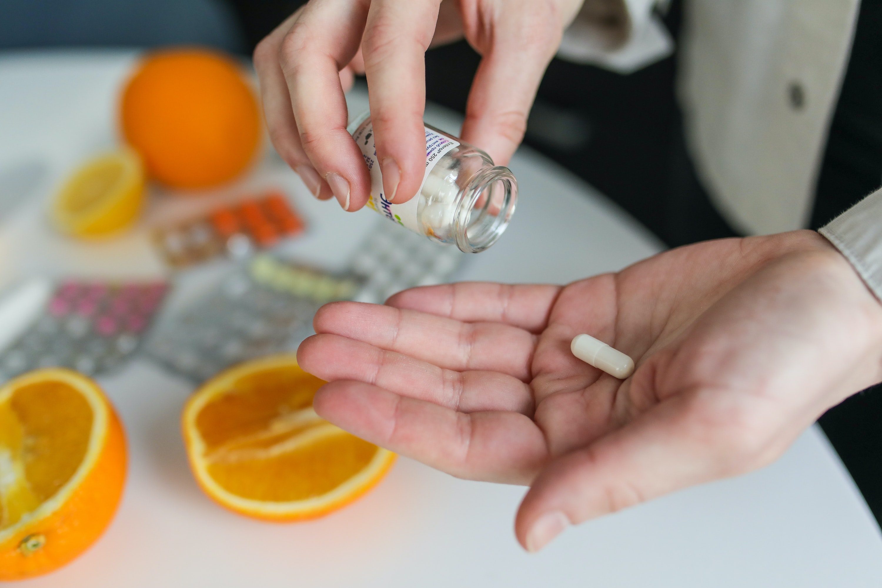 Person taking a pill.