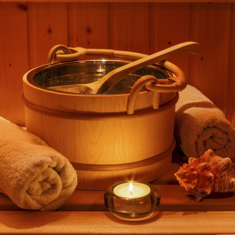 Sauna accessories in the glow of a tea light.