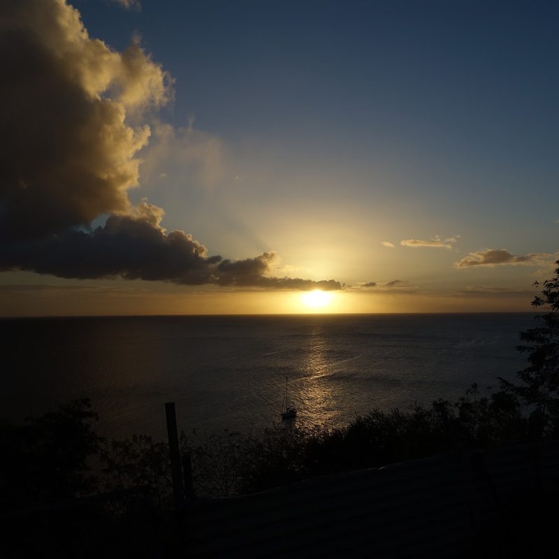 Silhouettes at sunset over a beach in Martinique.