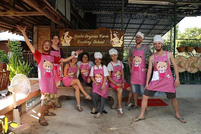 A group of people taking an authentic Thai cooking course on a TripAdvisor tour.