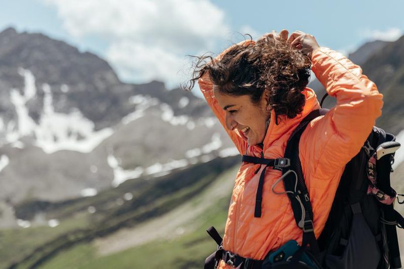 Smiling female hiker in the mountains.