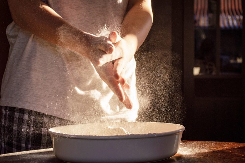 Person coating hands in flour