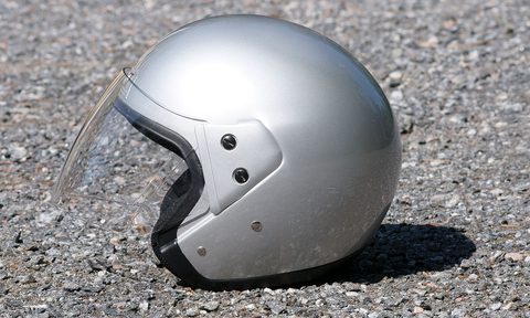 A side image of an open-faced motorcycle helmet.