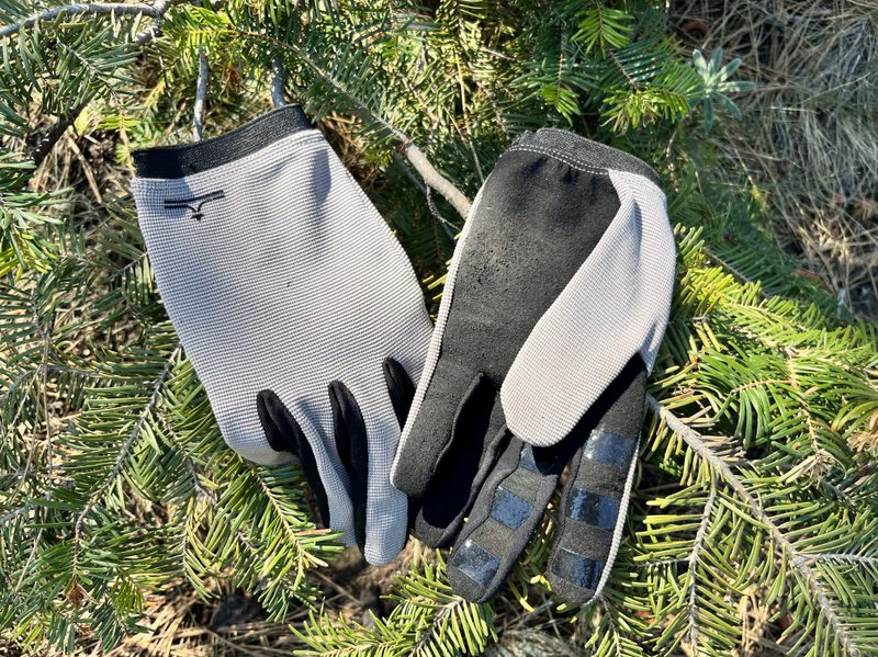 Evo's Peeler Bike Gloves sitting on some tree branches