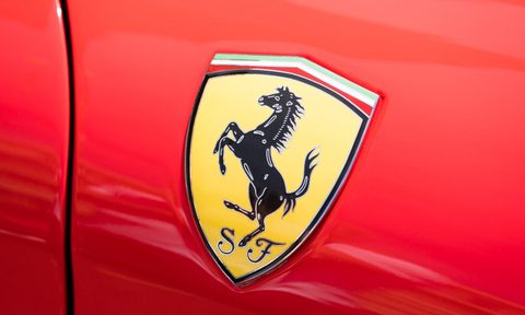 Close-up view of the logo of a Ferrari on public display in a car show