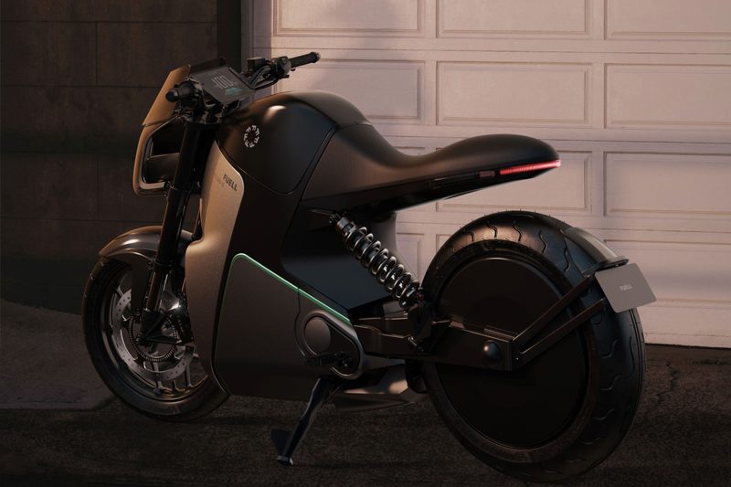 Fuell Fllow e-motorcycle parked in front of a garage door