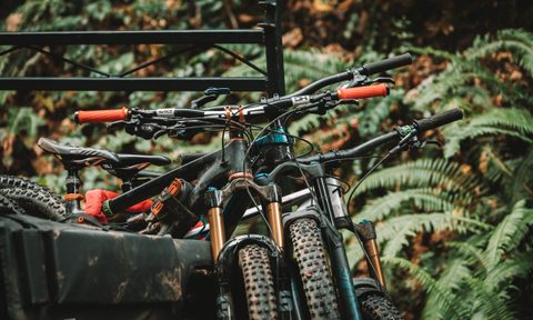 Mountain bikes resting in the back of a truck