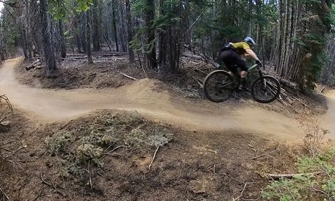 Jumping a gap on a mountain biking trail
