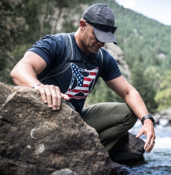 Man kneeling in water in Vertx Recon Pant