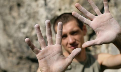 Man holding up callused palms of his hands