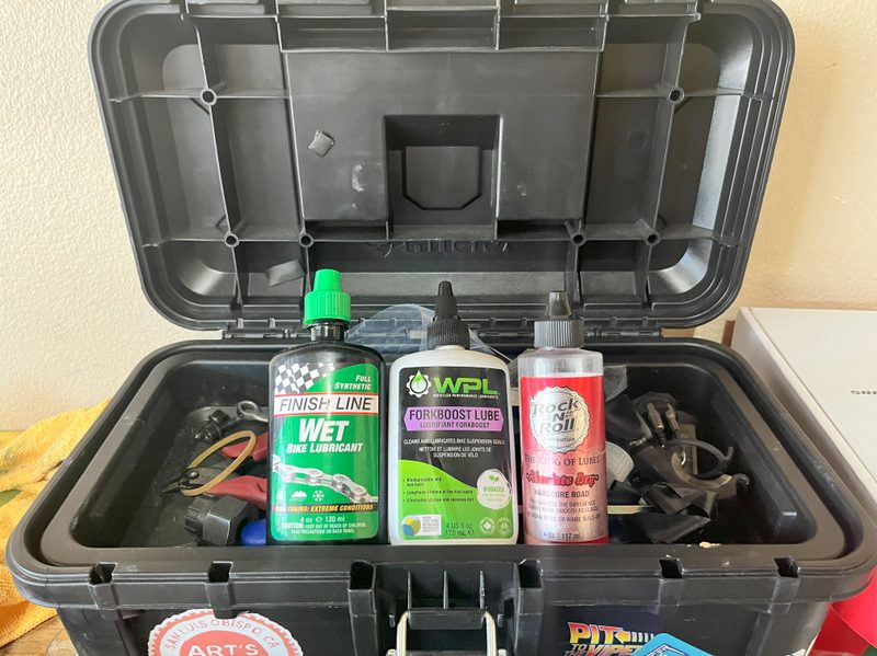 A picture of different lubrication needed for mountain bike maintenance...wet and dry chain lube, as well as suspension lubrication