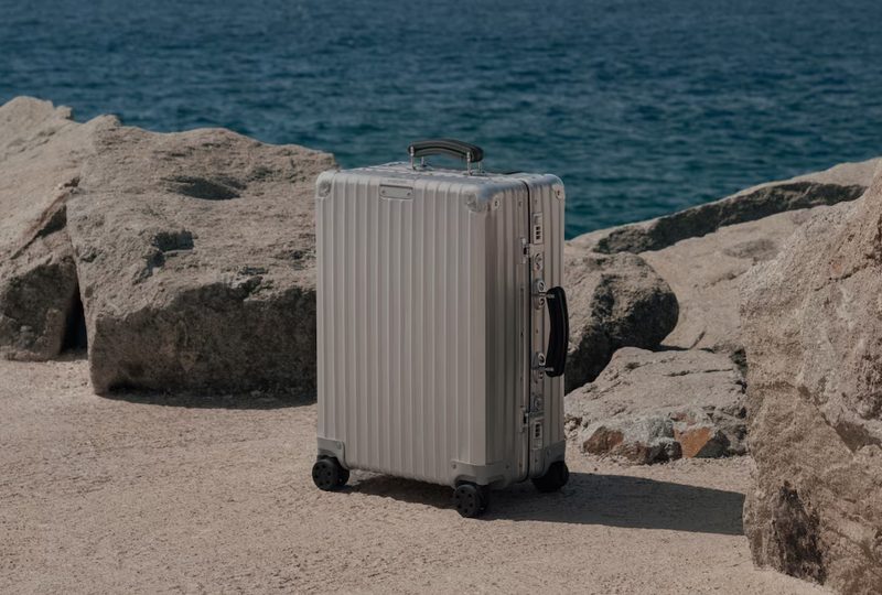 Rimowa suitcase by the beach.