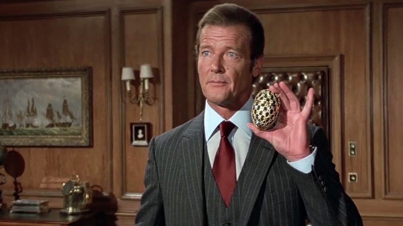Roger Moore holding a Faberge egg as James Bond.