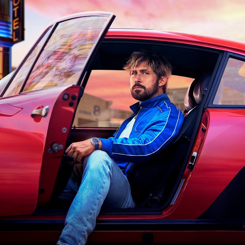 Ryan Gosling in a red car wearing a Tag Heuer watch