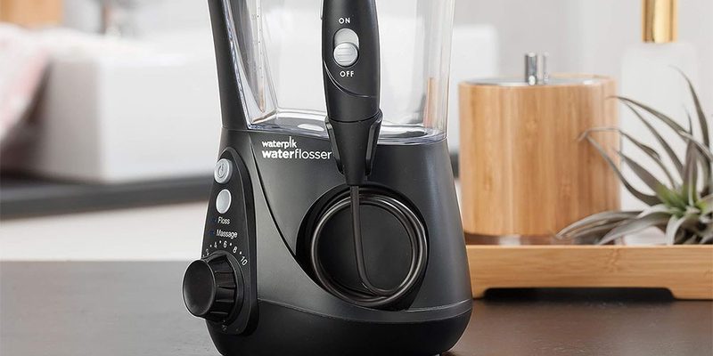 The Waterpik Aquarius Water Flosser on a table side.
