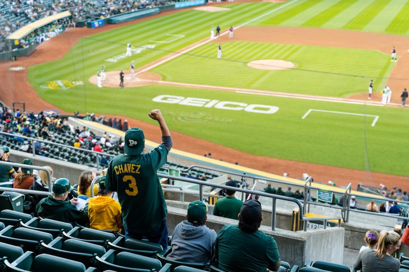 Fans cheering on a baseball game at the Coliseum.
