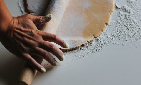 Person rolling pie dough