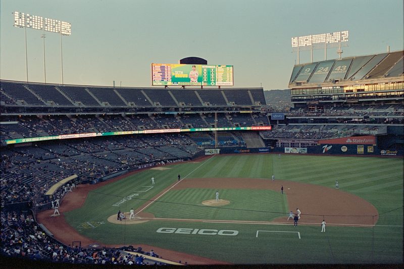 A baseball game being played with a crowd watching.