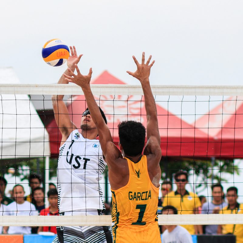 Men playing volleyball.