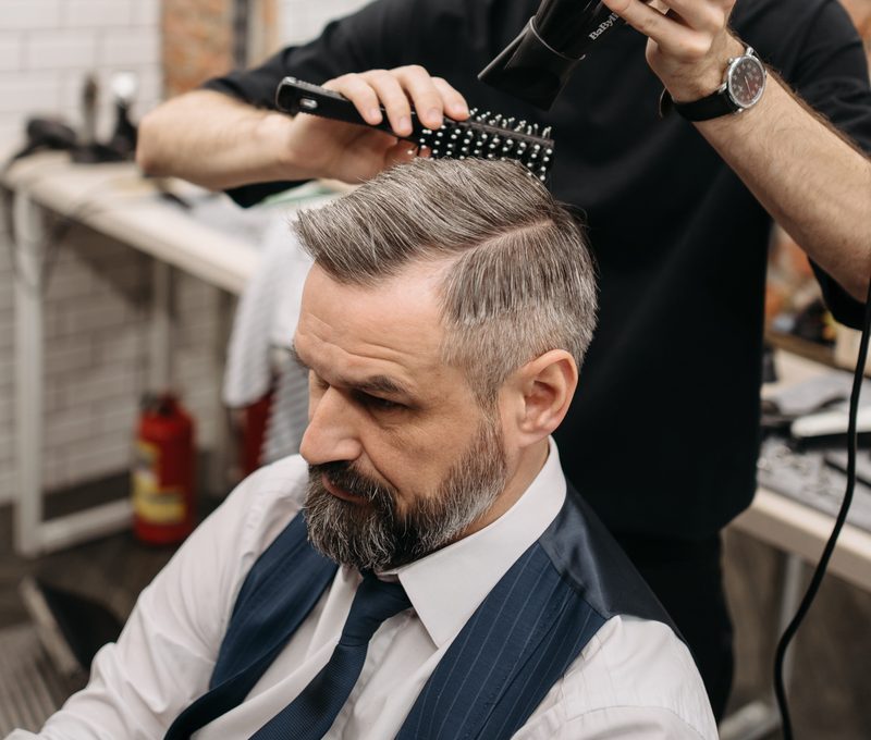 Barber cutting a brush cut