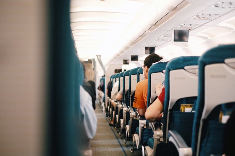 Back view of people seated on an airplane