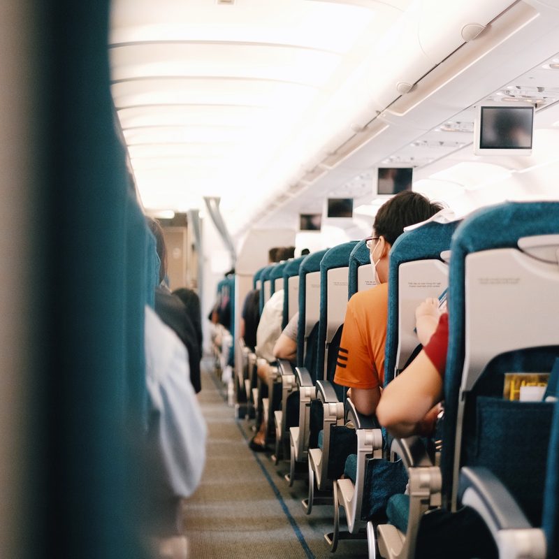 Back view of people seated on an airplane