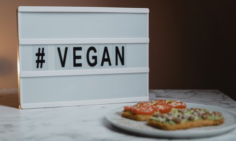 Vegan sign behind food plate