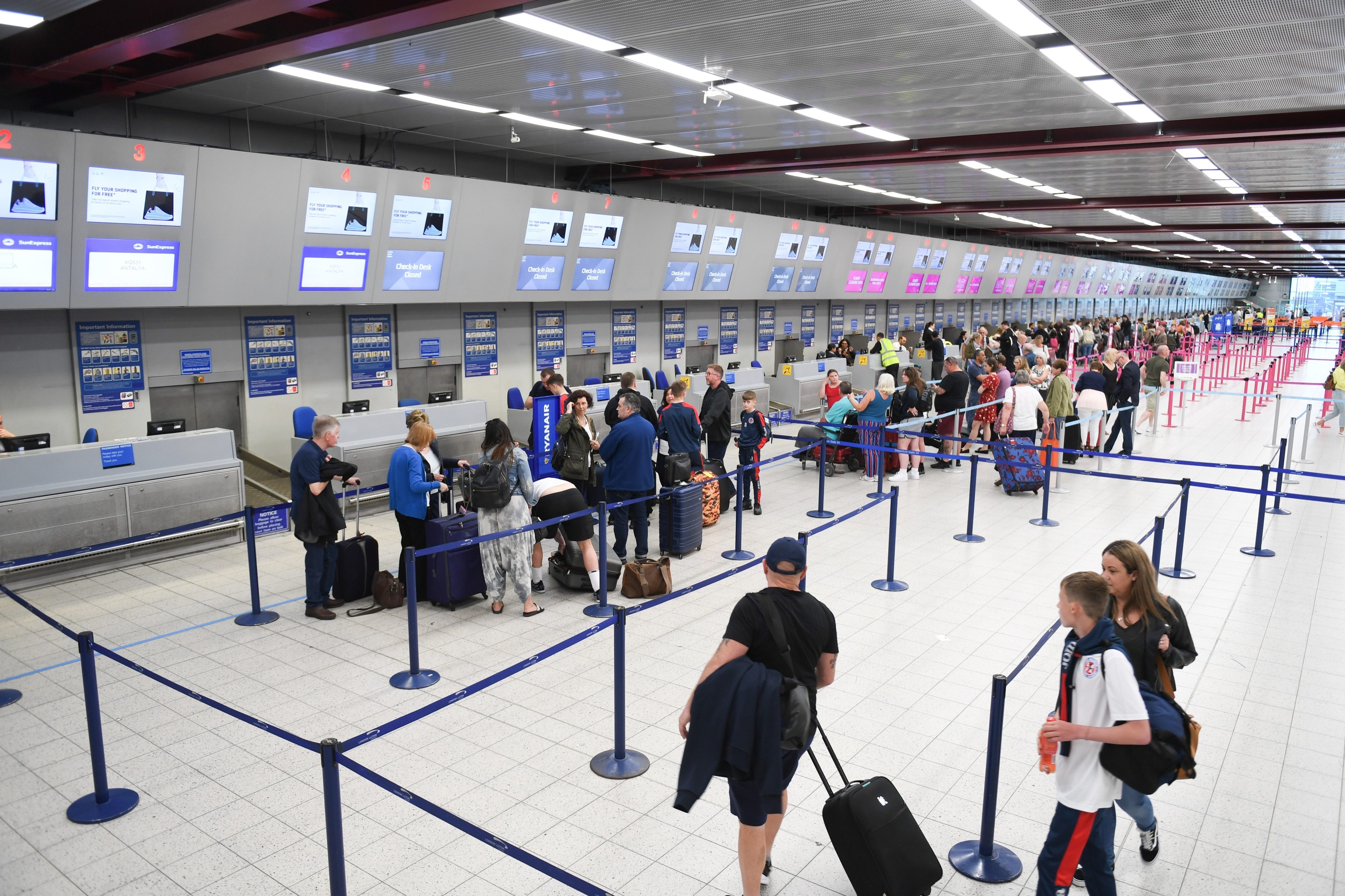 Passengers lining up to check in for flights at an airport