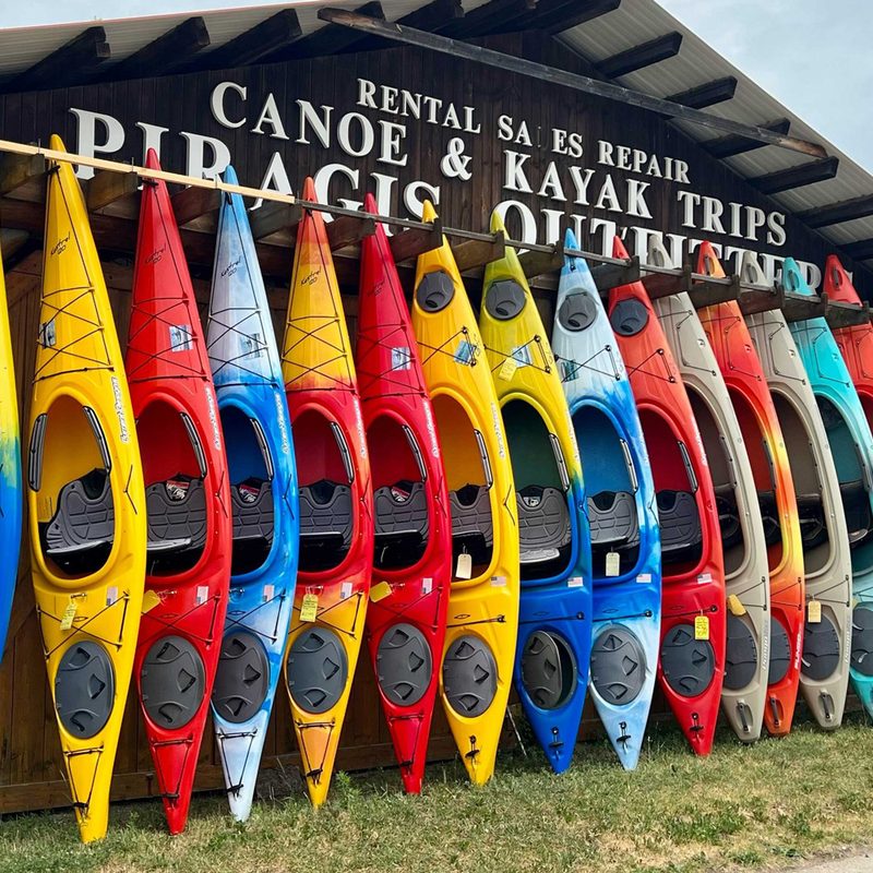 Colorful row of canoes lined up outside Piragis Northwoods Company in Ely, Minnesota.