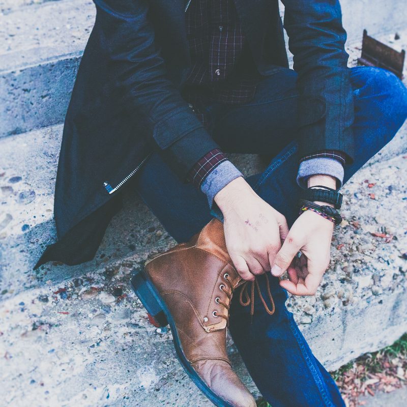 Man crossing legs in boots
