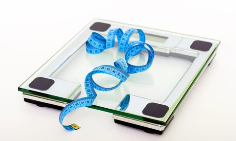 Clear glass scale with blue measuring tape