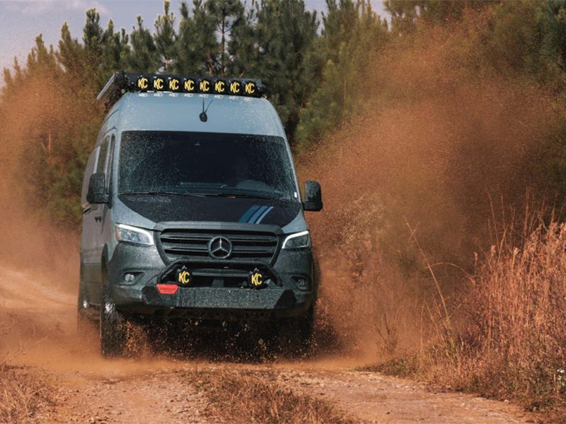 Storyteller Overland Beast Mode AWD campervan driving on a dirt road.