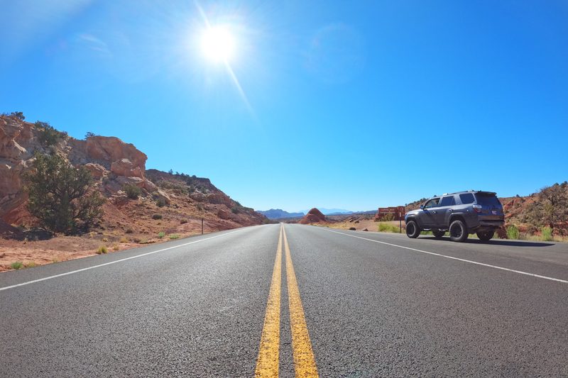 Looking down Utah Highway 24 near the Capitol Reef National Park entrance sign.