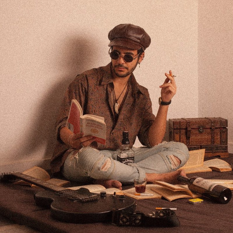 A stoned guy reading a book.