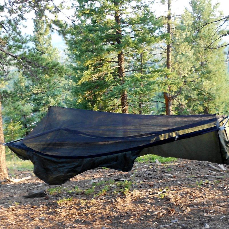 Warbonnet Ridgerunner Hammock hung between two trees in the woods.