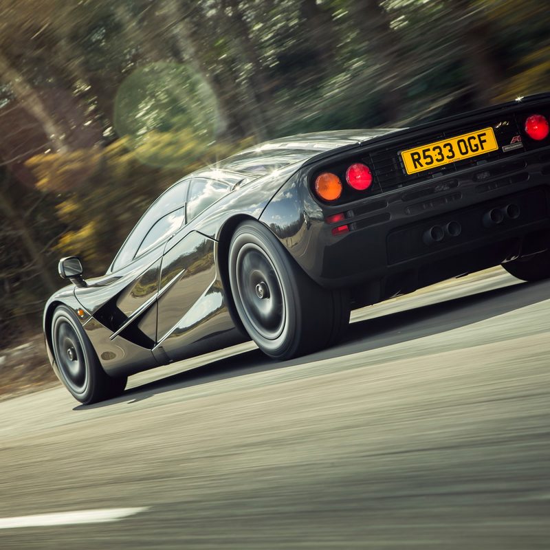 1992 McLaren F1 rear 3/4 view driving on road