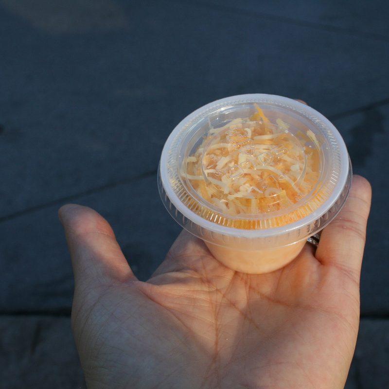 Shredded cheese in small cup
