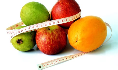 Fruit wrapped in measuring tape