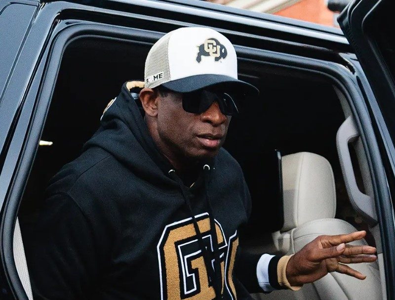 Deion Sanders wearing Blenders getting out of a car