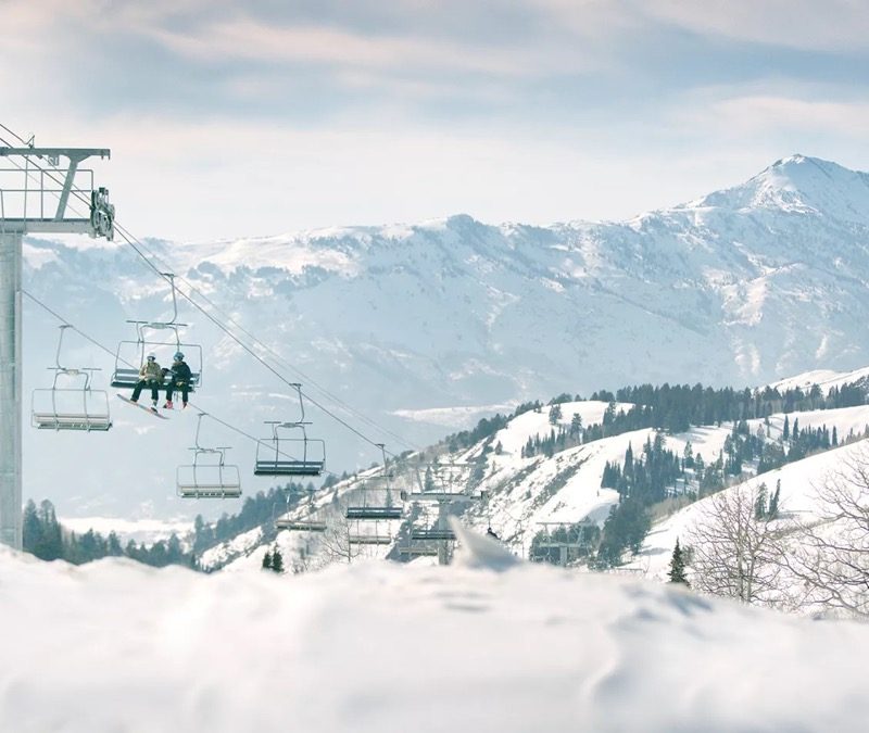A chairlift heads up a mountain promoting Ski Butlers.