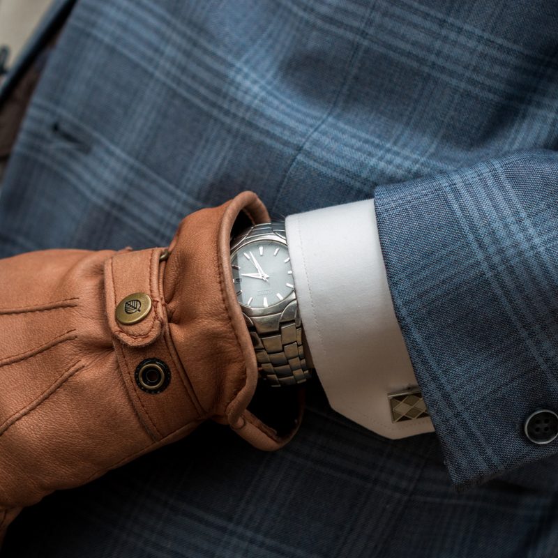 Man in suit, cufflinks, watch, and gloves